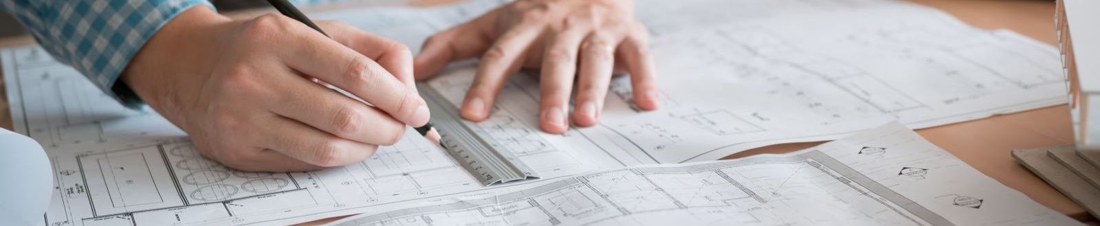 Man drawing on blueprints