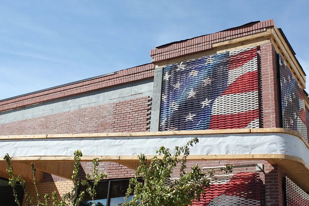 Exterior of Round Robin with IQ Brick siding and American flag